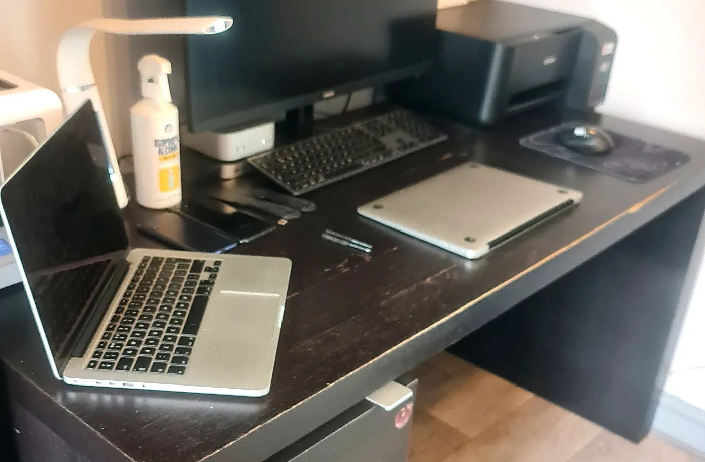 The @Compu-Tech repair bench in Horbury, with a laptop motherboard, tools and diagnostic equipment